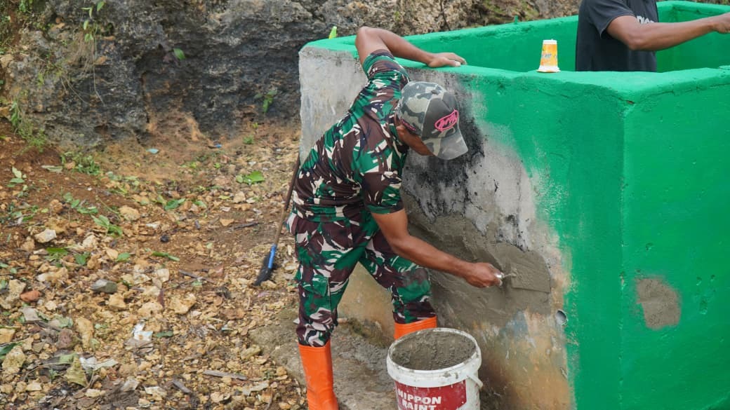 Kolaborasi Satgas TMMD Ke-129 dengan Warga Umbele dalam Pengecatan Tempat Sampah